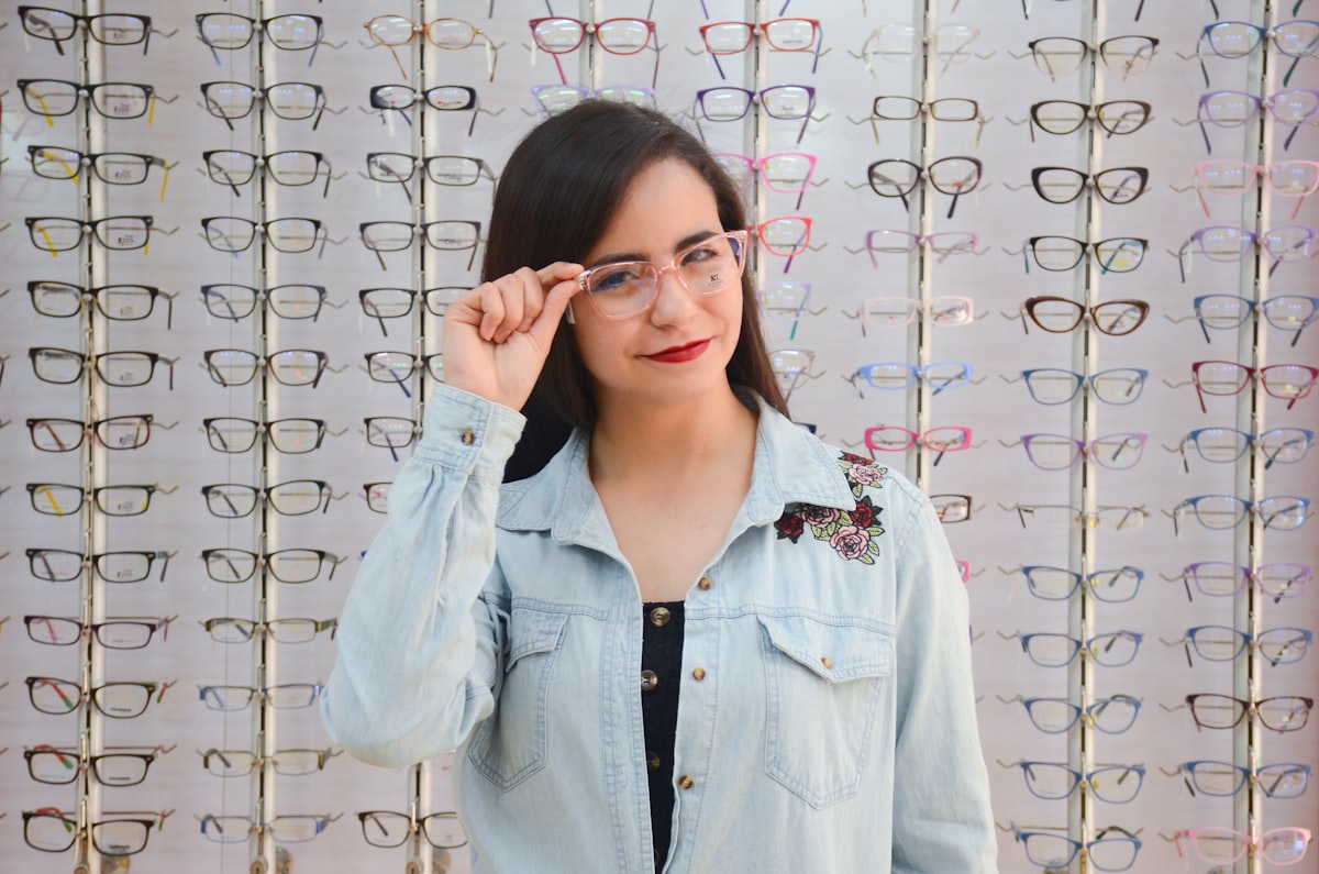 A happy customer trying on new prescription glasses at LordSolace Optical Venture, Lagos Island